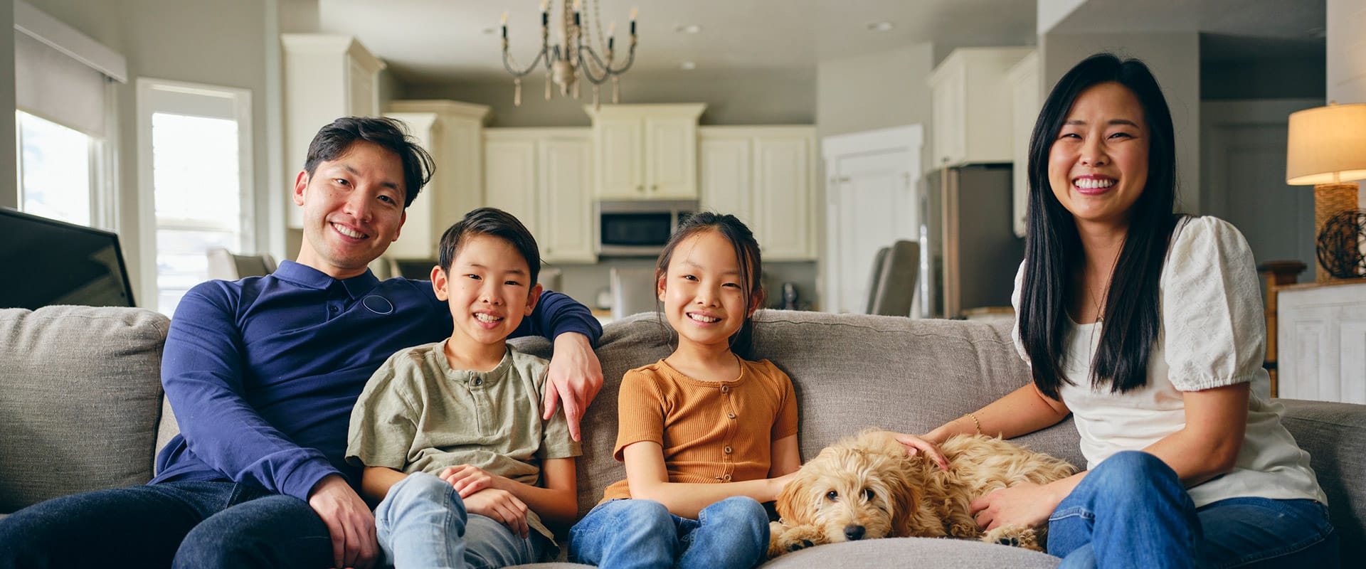 Family relaxing together at home, everyone smiling